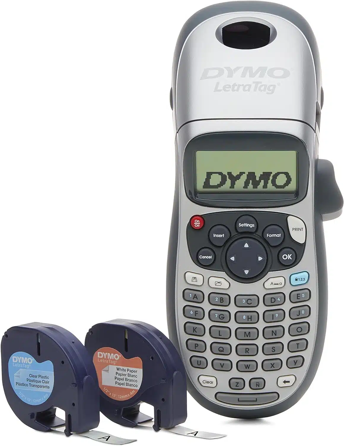 The image shows a DYMO LetraTag label maker. It has a compact, handheld design with a small screen and a full QWERTY keyboard. The label maker is silver and gray with various function buttons, including settings, insert, format, and print. The display shows the text "DYMO." Two label cartridges are included in the image, one labeled "Clear Plastic" and the other "White Paper."
