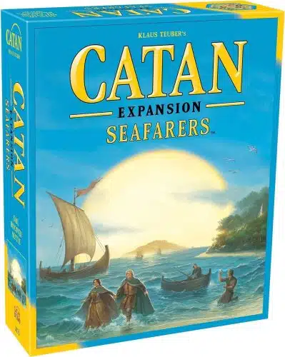 The front cover of the board game "Catan Expansion: Seafarers" by Klaus Teuber. The artwork features a bright, sun-drenched coastal scene under a clear blue sky. In the foreground, two settlers wade through ocean waves toward a sandy beach, while a small rowboat and a larger sailing ship with a single mast are visible nearby. The game title "CATAN" is written in large yellow serif letters at the top, followed by the words "EXPANSION" and "SEAFARERS" in gold.